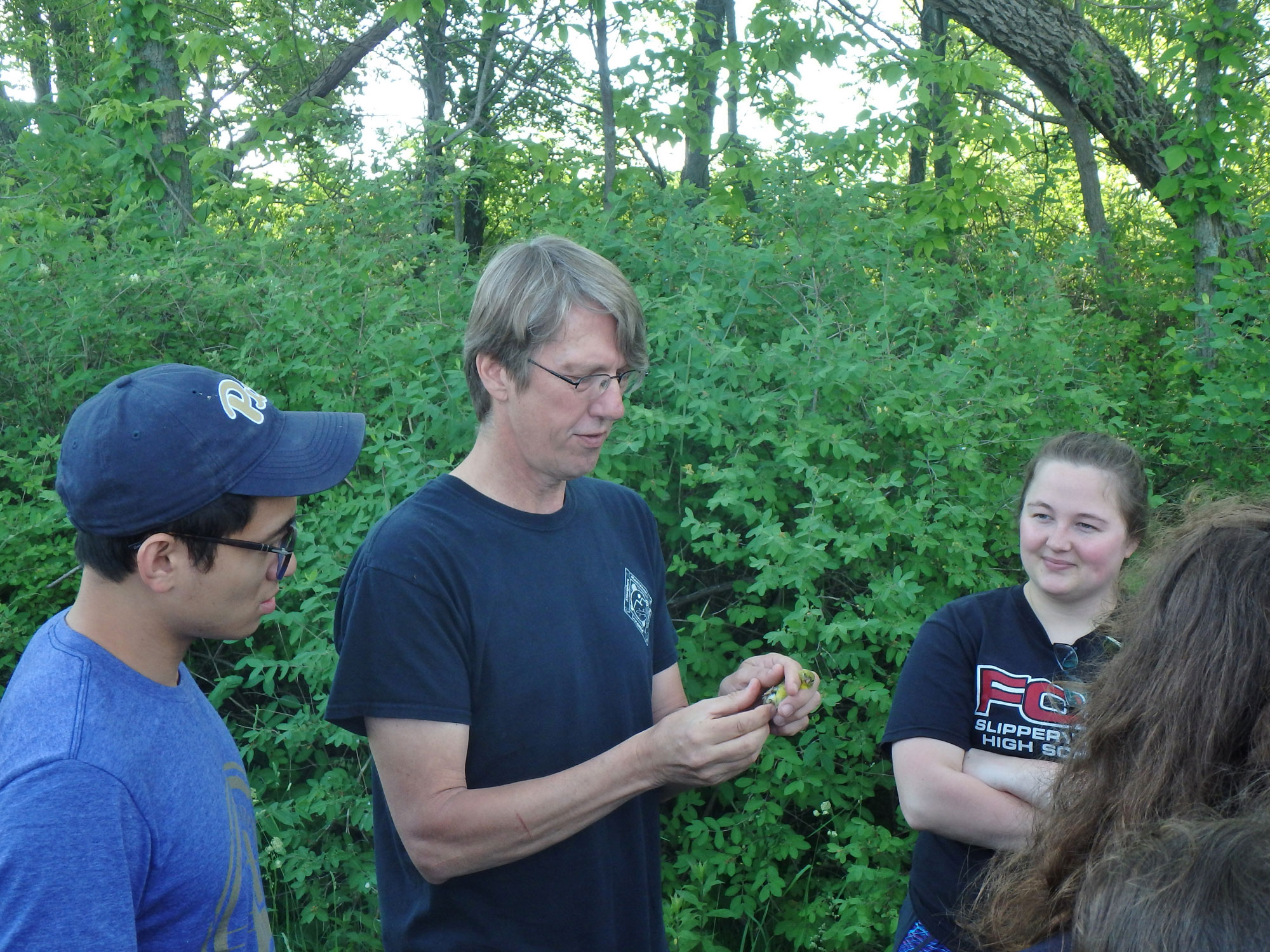 instructor showing students a bird